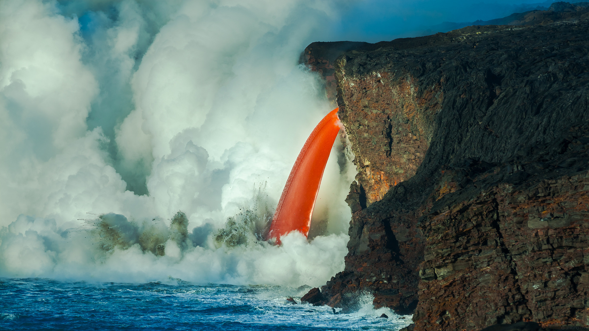 Lava Waterfall, Kilauea Volcano, Hawaii - Lava from the Kilauea volcano flowing into the Pacific Ocean on Jan 30th, 2017 (61G ocean entry). It is considered an unusual phenomenon by geologists. The 'waterfall' was formed after a portion of the Kamokuna lava delta collapsed